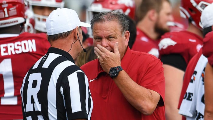 Razorbacks coach Sam Pittman talking with an official during a game at Razorback Stadium